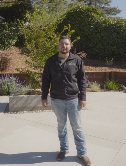 True Green Landscaping owner Giovanni standing in a finished backyard