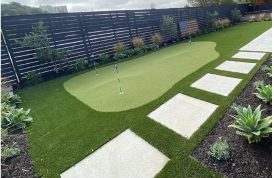 Artificial turf backyard with putting green and stepping stones